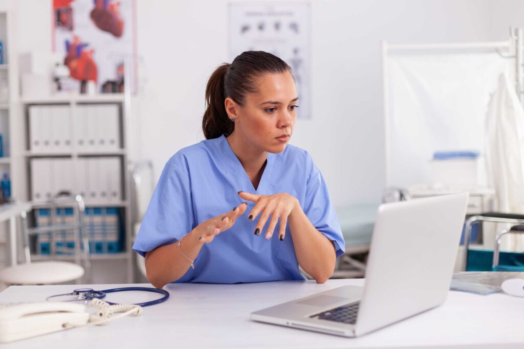 nurse reading something on laptop
